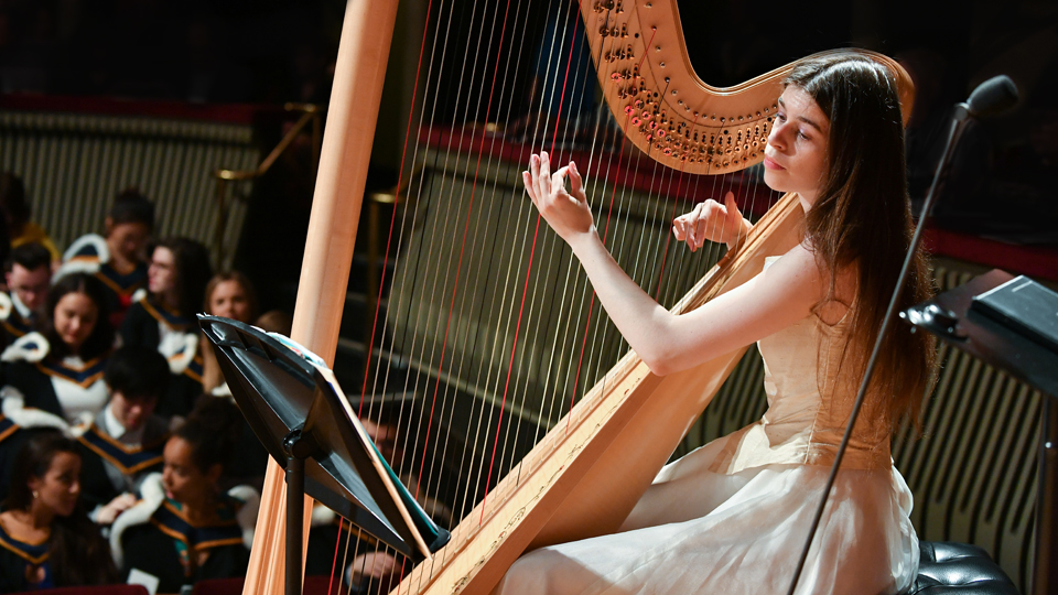 Harpist playing at graduation in the Britten Theatre